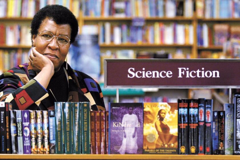 Science Fiction writer Octavia Butler poses for a photograph near some of her novels at University Book Store in Seattle, Wash., on Feb. 4, 2004. Butler, considered the first black woman to gain national prominence as a science fiction writer, died Friday, Feb. 24, 2006, after falling and striking her head on the cobbled walkway outside her Seattle home, a close friend said. She was 58. (AP Photo/ Seattle Post-Intelligencer, Joshua Trujillo) ORG XMIT: WASEA101