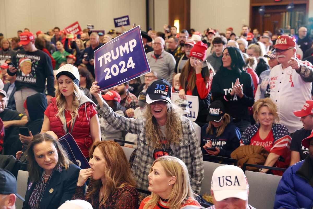 Supporters of former President Trump attend a campaign rally in Coralville, Iowa, on Dec. 13. 