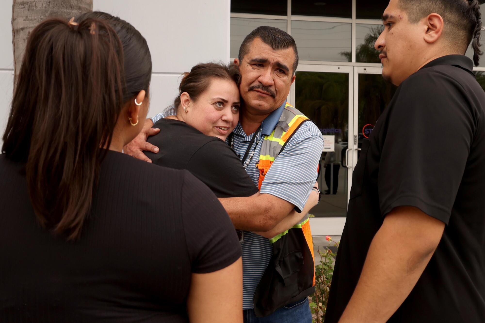 Noel H., a vendor at an STG Logistics facility in Compton, hugs a family member.