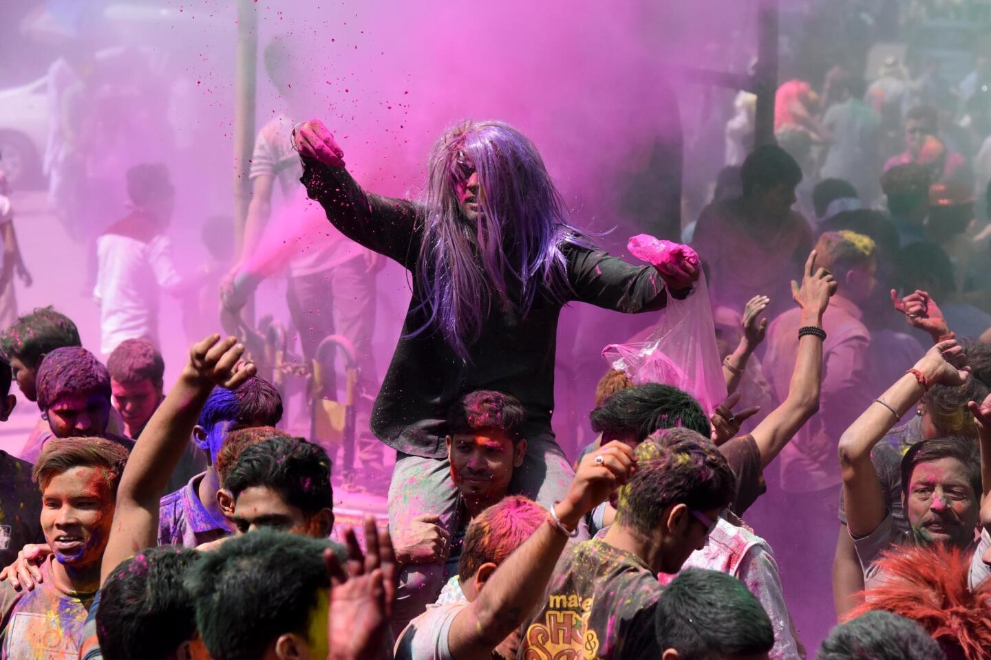 People dance as color is sprayed around during Holi on March 13, 2017, in Guwahati, India. Holi, also known as the Festival of Colors, heralds the beginning of spring and is celebrated all over India.