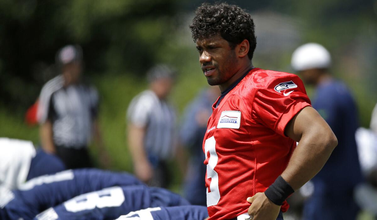 Seattle Seahawks quarterback Russell Wilson stretches before practice on Wednesday.