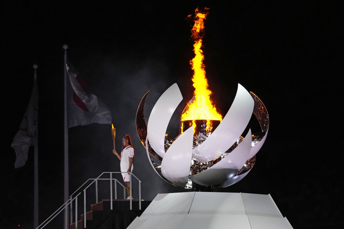 Naomi Osaka lights the Olympic cauldron at the Tokyo Olympics.