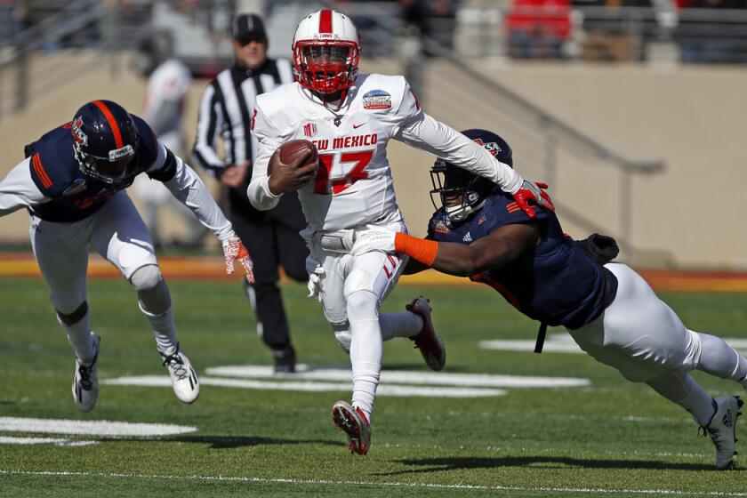 New Mexico quarterback Lamar Jordan, center, is sacked by UTSA safety Michael Egwuagu during the first half of the New Mexico Bowl on Saturday.