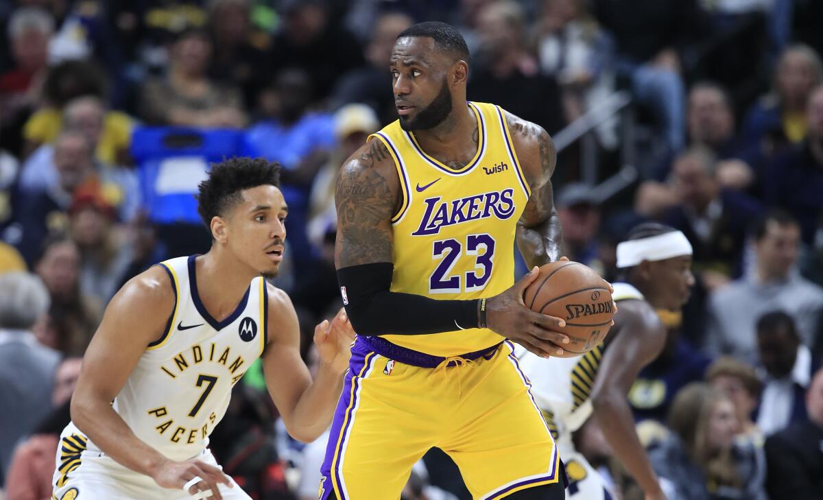 Lakers forward LeBron James is defended by Pacers guard Malcolm Brogdon during a game Dec. 17, 2019, at Indianapolis.