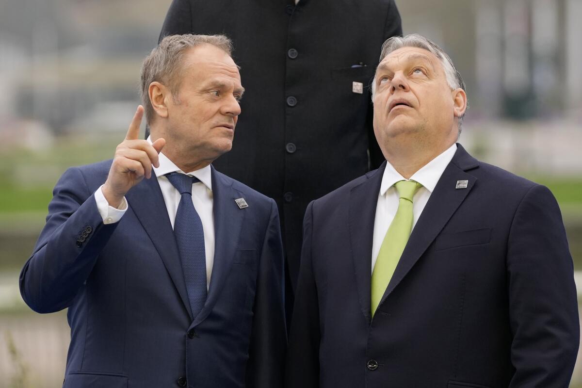 Hungary's Prime Minister Viktor Orban, right, speaks with Poland's Prime Minister Donald Tusk in Brussels.