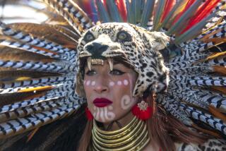 Jovanna Loeza dances with the Calpulli Cencalli during the Indigenous Peoples Day East Los Angeles music, arts and culture festival in the Malinalli Superfoods parking lot in the East Los Angeles area of LA on Oct. 8, 2023.
