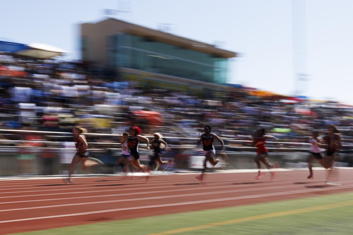 Runners compete in the girls' 100-meter dash at Moorpark High on May 13.