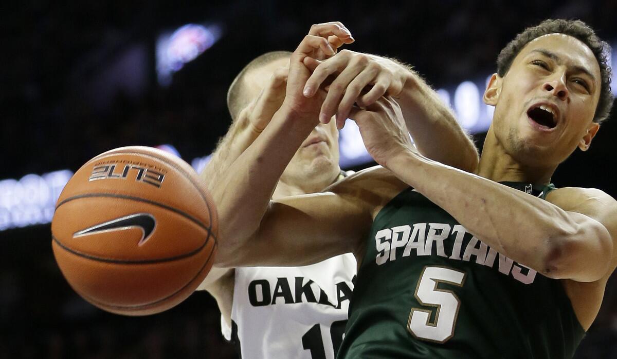 Michigan State guard Bryn Forbes (5) is fouled by Oakland guard Max Hooper during the second half on Tuesday.