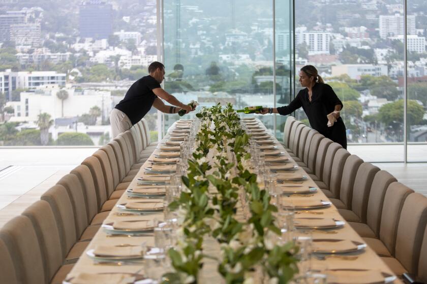 West Hollywood, CA - June 15: Wine is poured as staff prepares a five-course dinner during a VIP event at 8899 Beverly, one of the most exclusive condo residences ever built on Wednesday, June 15, 2022 in West Hollywood, CA. (Brian van der Brug / Los Angeles Times)