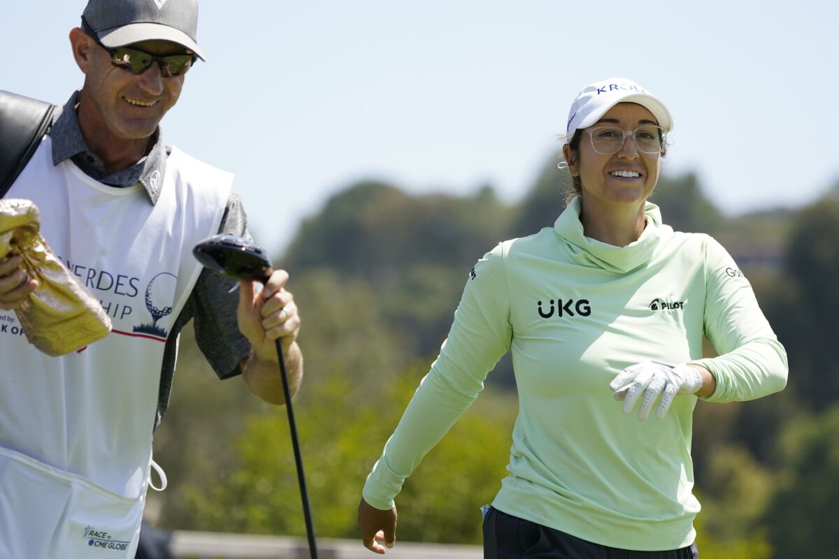 Marina Alex laughs with her caddie, Brendan Woolley, as they leave the fourth tee during the final round of the LPGA's Palos Verdes Championship golf tournament on Sunday, May 1, 2022, in Palos Verdes Estates, Calif. (AP Photo/Ashley Landis)