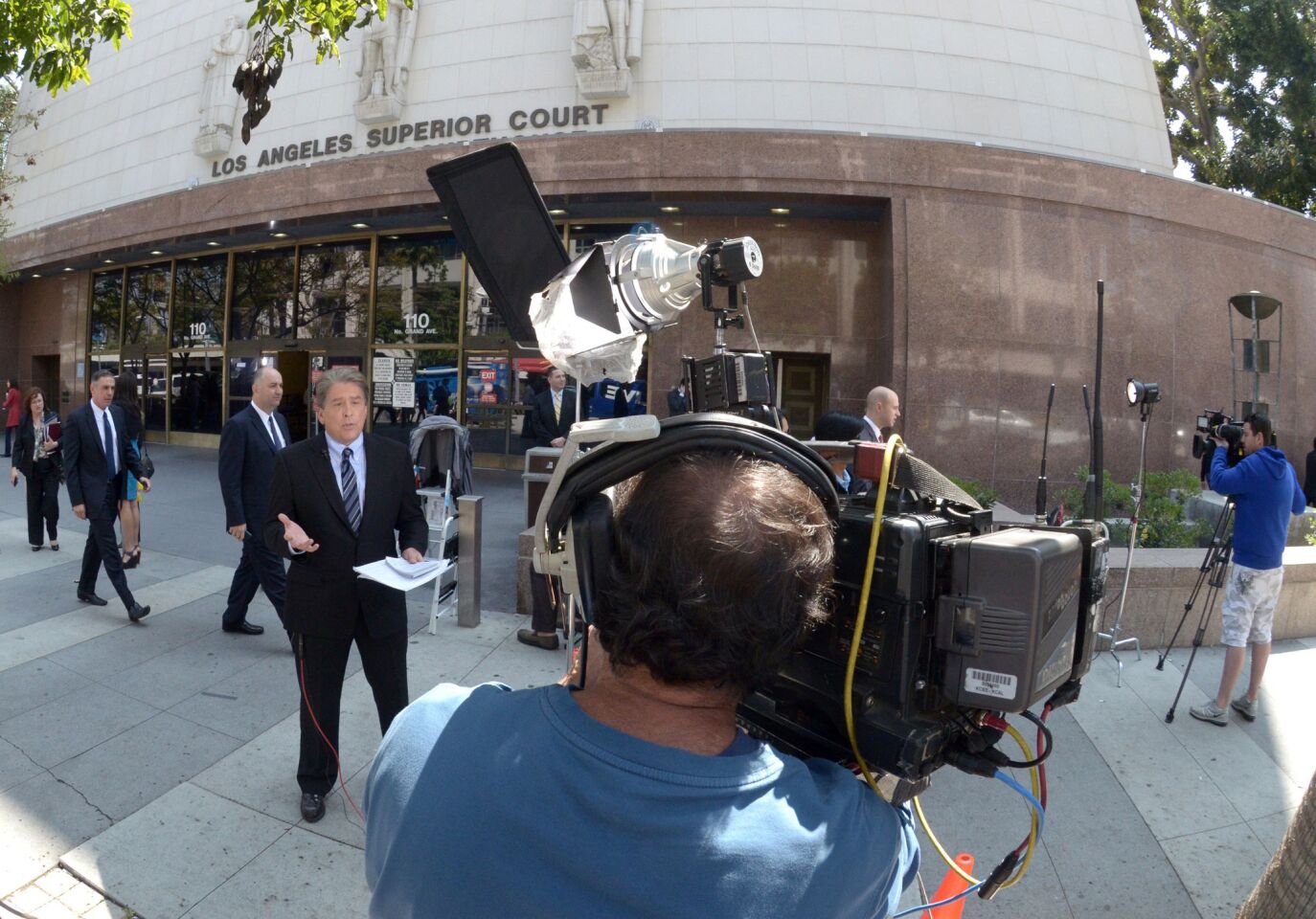 Television crews report live outside Los Angeles County Superior Court in downtown Los Angeles on the first day of the trial in the wrongful-death lawsuit.