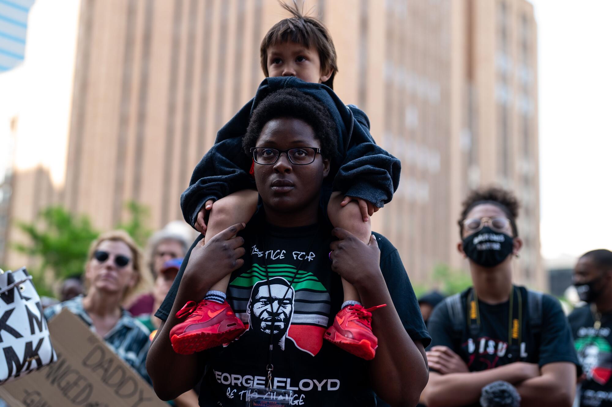 Alexis Rodgers, 21, of Minneapolis, with Caden, 3, on her shoulders.