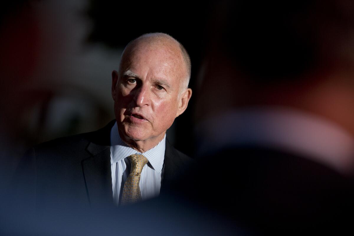 Gov. Jerry Brown talks to reporters outside the Old Governors Mansion on primary night in Sacramento on June 3.