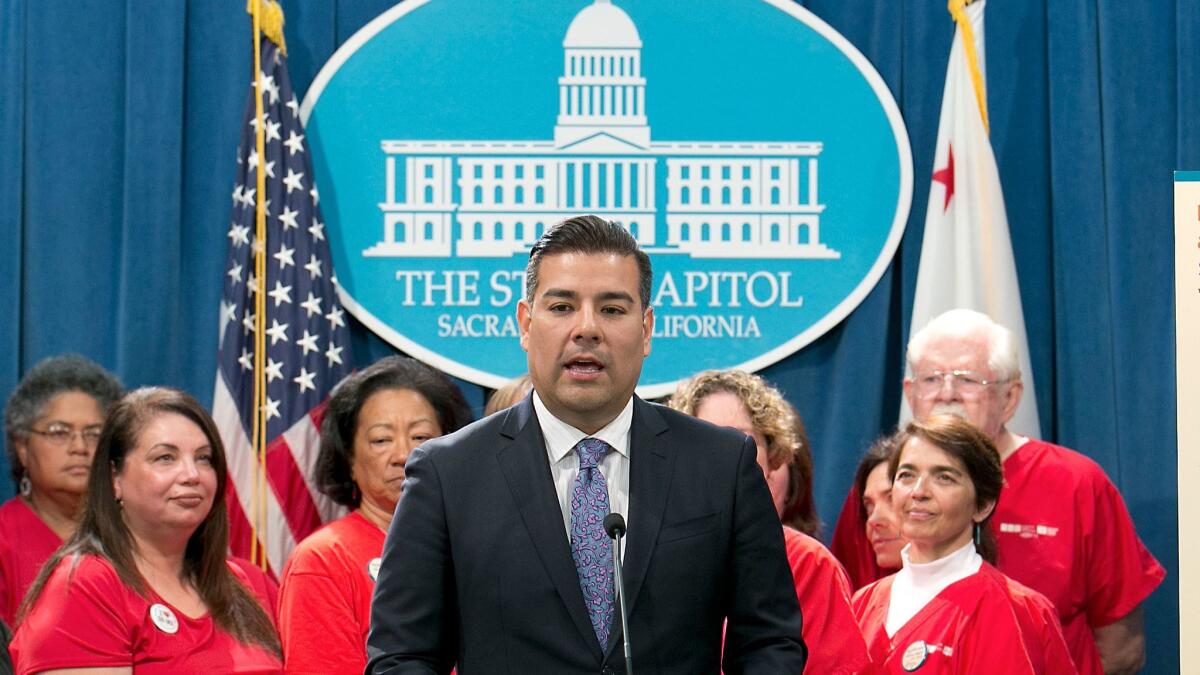 State Sen. Ricardo Lara, D-Bell Gardens, accompanied by members of the California Nurses Association, discusses his single-payer health care bill at a Capitol news conference on May 31 in Sacramento, Calif.