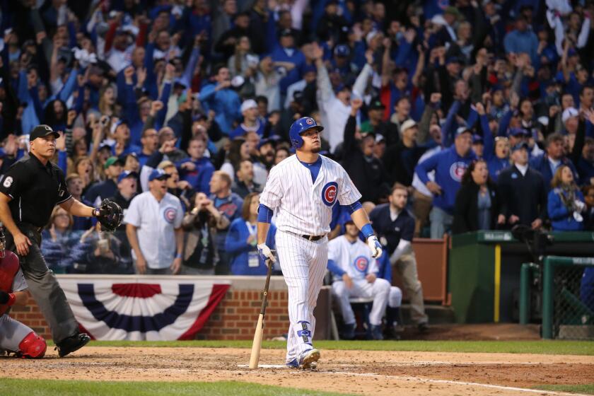 Kyle Schwarber watches his solo home run in the 7th inning off of Cardinals relief pitcher Kevin Siegrist during Game 4 of the NLDS at Wrigley Field.