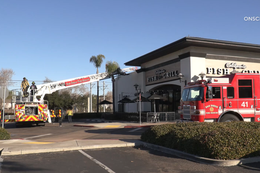San Diego firefighters rescued a suspected burglar off the roof of a Mission Valley restaurant.
