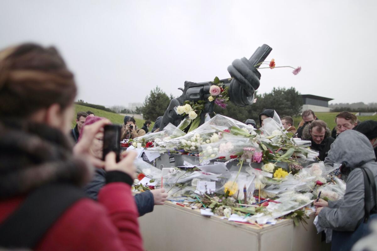 Flowers at Memorial Square in Caen, in northwestern France, to honor the Charlie Hebdo cartoonists killed by terrorists. An area museum canceled a cartooning conference because of security issues.
