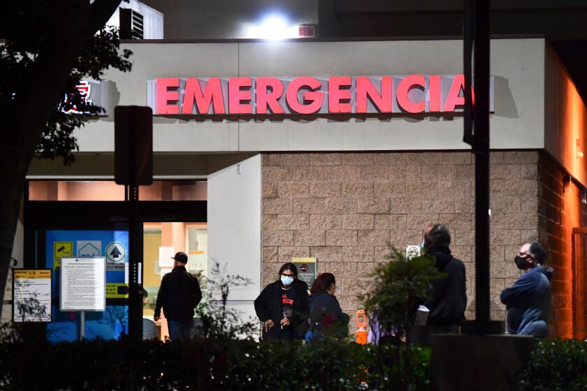 People wait outside the Emergency room of the Garfield Medical Center in Monterey Park, California on December 1, 2020. - A county-wide coronavirus regulations went into effect again on November 30 for three weeks amid ever increasing numbers of positive Covid-19 cases and fears of overwhelmed hospitals. Aid for restaurants will begin on December 3, with the start of the Keep Los Angeles County Dining Grant Program , allowing eligible restaurants which have lost business due to countywide coronavirus health regulations to apply for and receive up to $30,000 in aid. (Photo by Frederic J. BROWN / AFP) (Photo by FREDERIC J. BROWN/AFP via Getty Images)