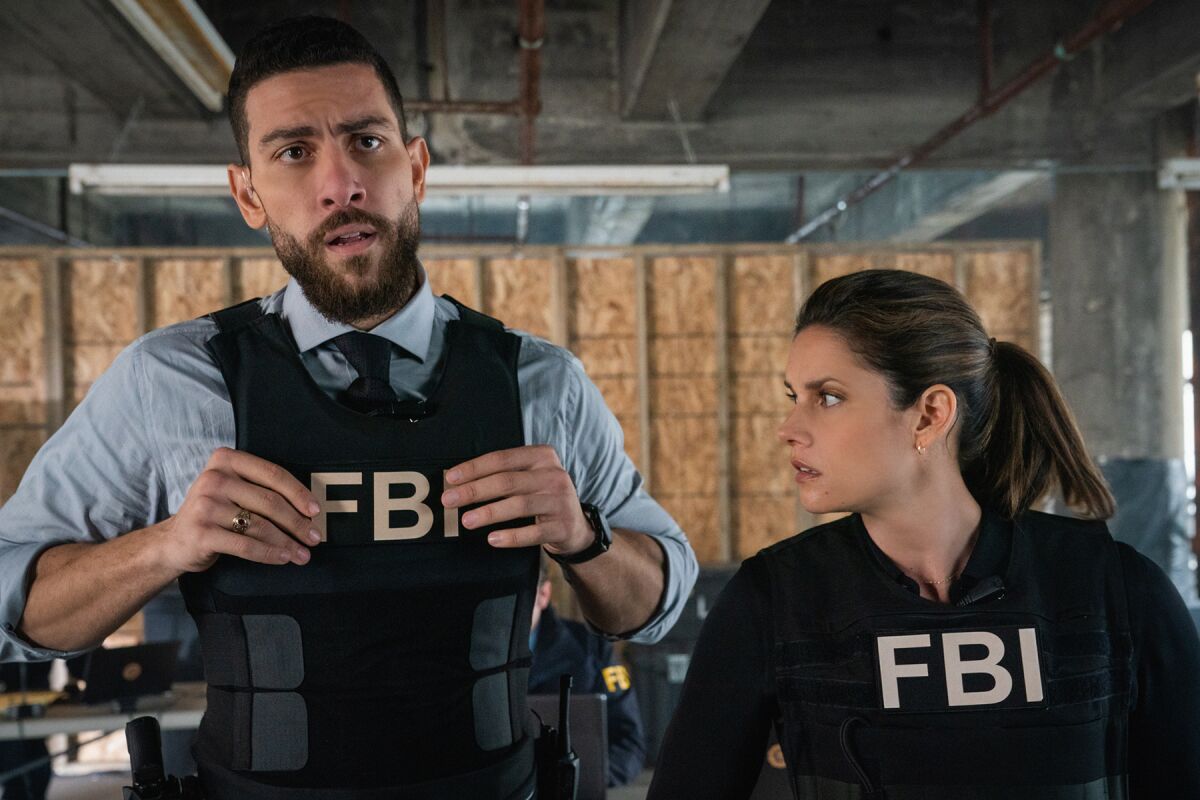 Zeeko Zaki and Missy Peregrym wearing FBI vests on "FBI" on CBS.