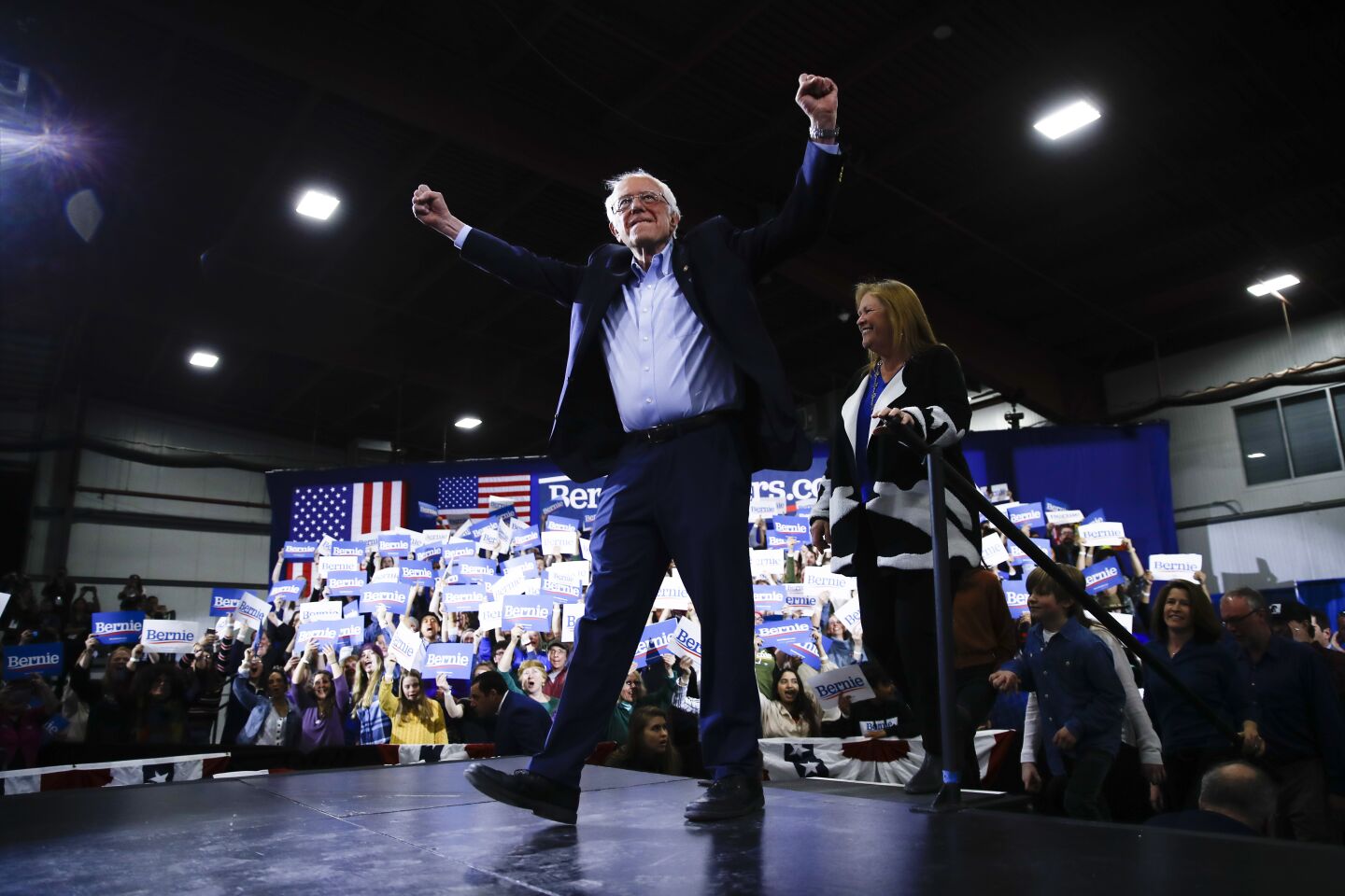 Bernie Sanders pumps his fists in the air.