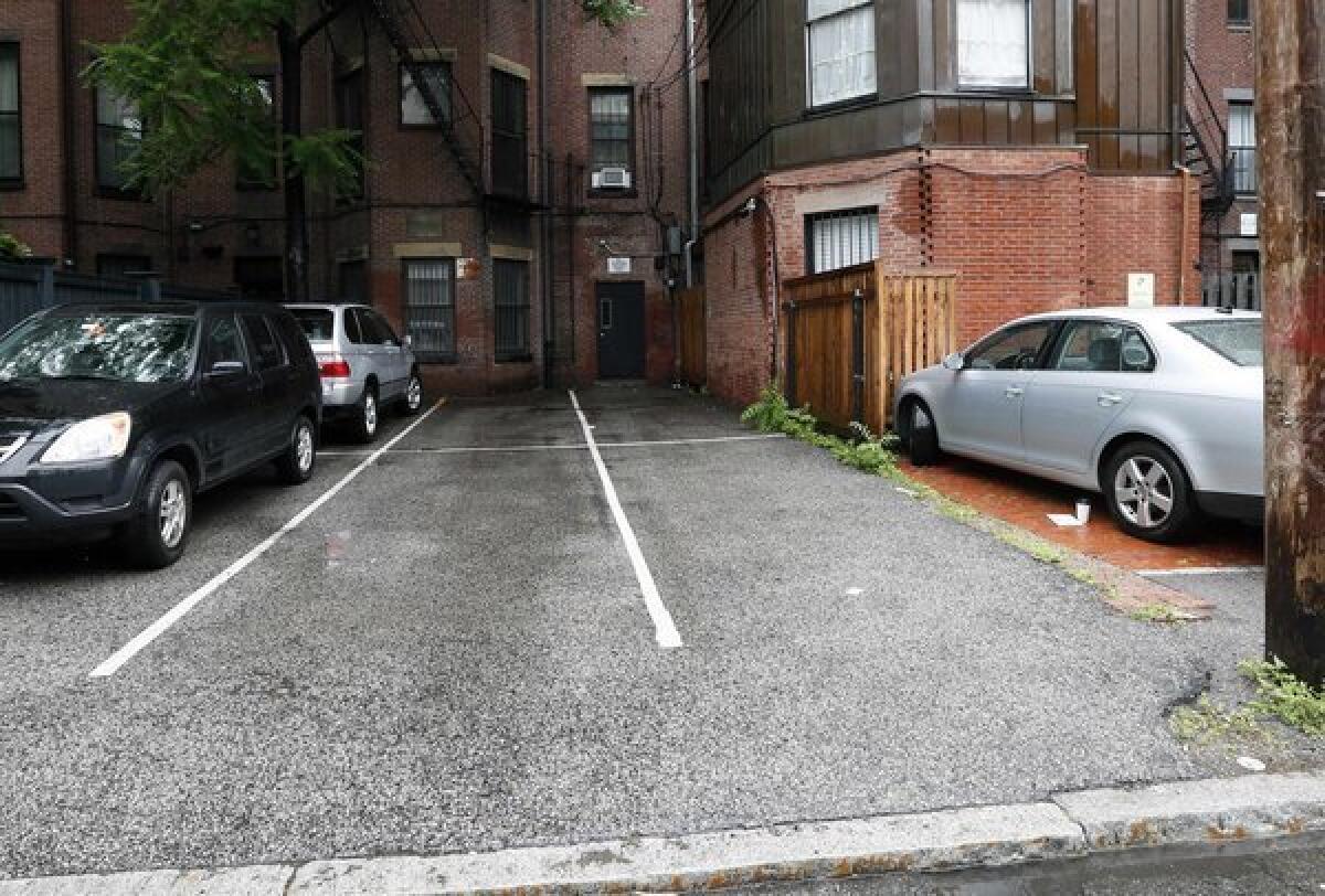 The two open parking spaces at right, front and back, in Boston's Back Bay area were sold at auction Thursday for $560,000.