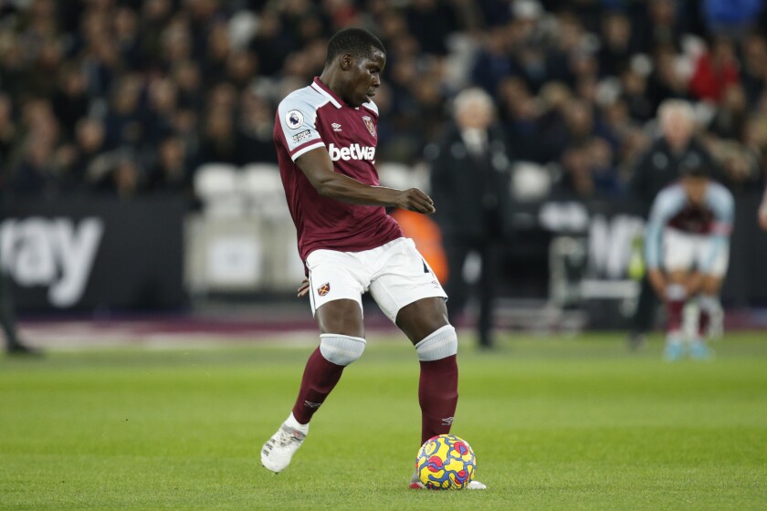 West Ham's Kurt Zouma plays the ball during an English Premier League soccer match between West Ham United and Watford at the London stadium in London, Tuesday, Feb. 8, 2022. (AP Photo/David Cliff)