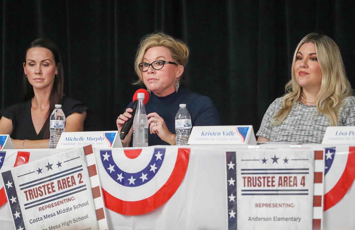 Michelle Murphy, center, speaks as Danielle Mills, and Kristen Valle, listen, during a NMUSD candidate forum Monday.