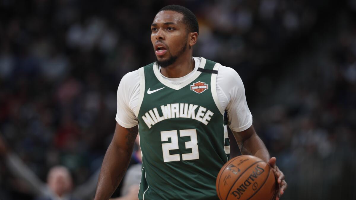 Bucks guard Sterling Brown brings the ball up court during a game against the Nuggets on March 9, 2020, in Denver.