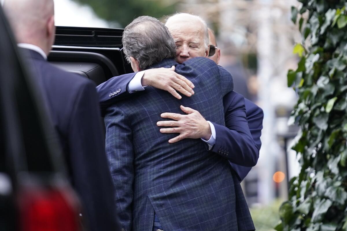 President Joe Biden hugs his son Hunter Biden on Hunter's birthday after dining at The Ivy in Los Angeles.