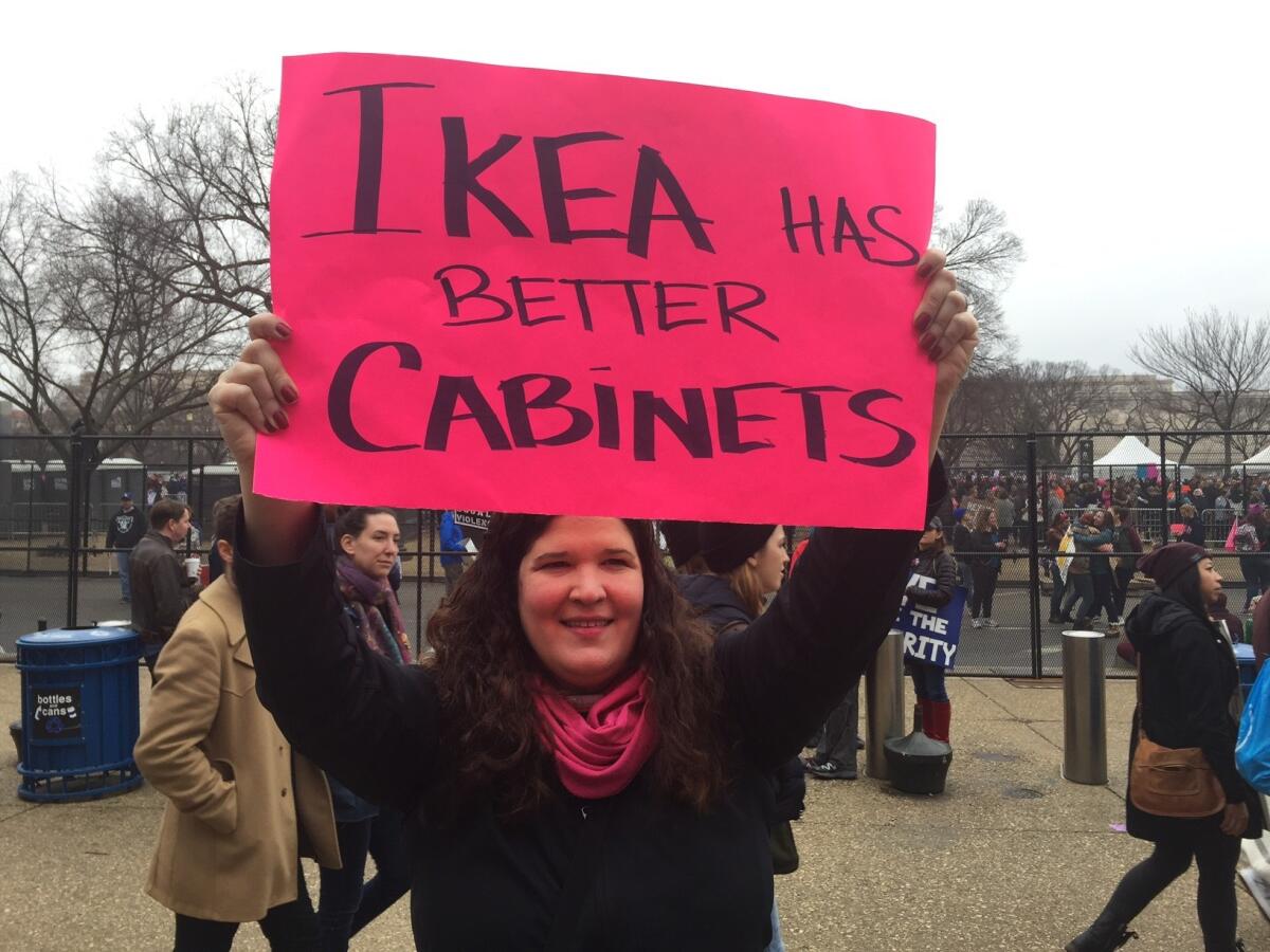 This protester took aim at Trump's Cabinet, the least diverse of recent administrations, both Democratic and Republican. It's the first since 1989 with no Latinos.
