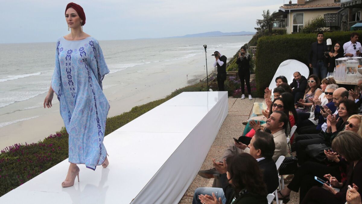 A model displays her outfit during an Artizara fashion show Sunday in Encinitas.