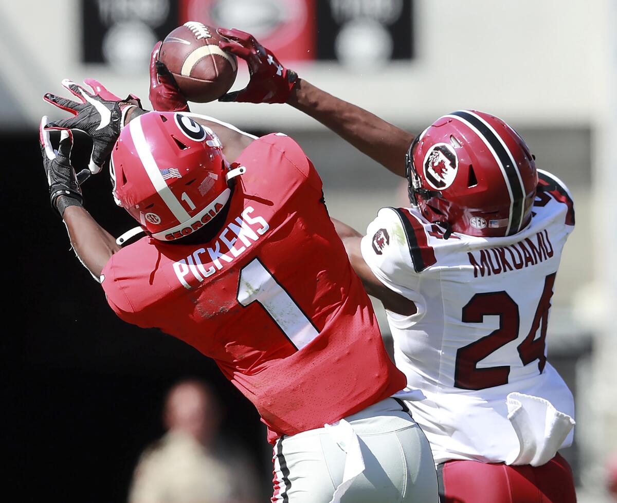 South Carolina's Israel Mukuamu intercepts a pass intended for Georgia's George Pickens on Saturday.