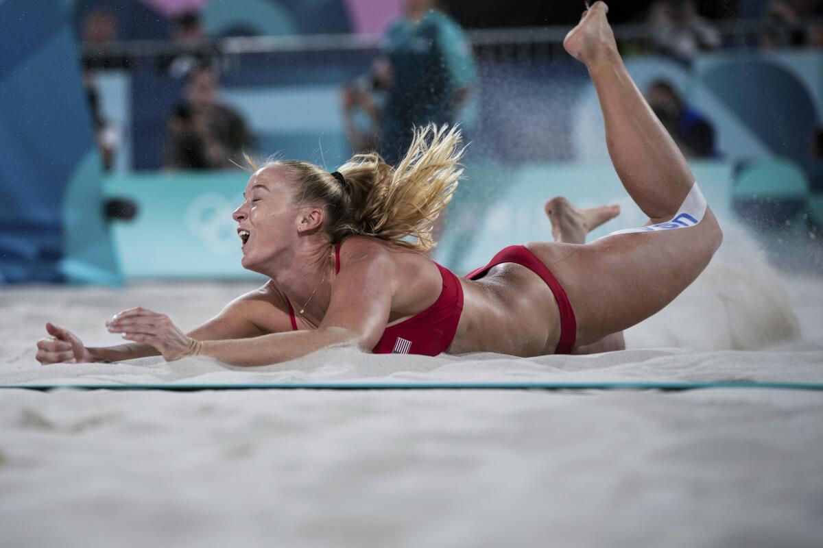 American Sara Hughes lands after diving for the ball during the quarterfinal beach volleyball match against Switzerland 