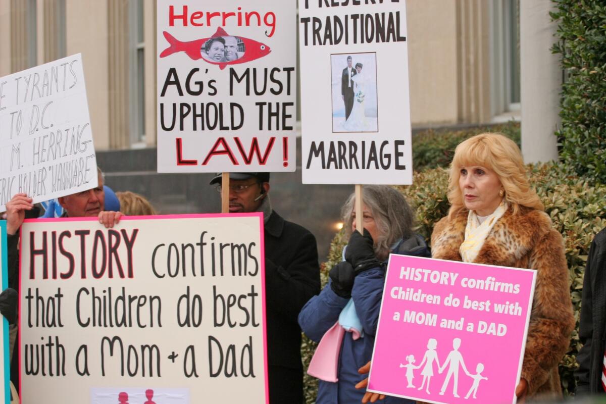 People protest gay marriage outside the Walter E. Hoffman U.S. Courthouse as oral arguments in the case of Bostic vs. Rainey proceed on Feb. 4, 2014, in Norfolk, Va. Virginia Atty. Gen. Mark Herring has concluded that Virginia's ban on gay marriage is unconstitutional and says that he will no longer defend it in federal lawsuits.