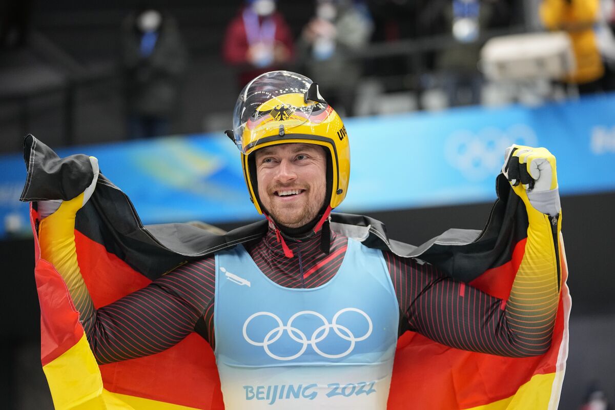 FILE - Johannes Ludwig, of Germany, celebrates winning the gold medal in luge men's single at the 2022 Winter Olympics, on Feb. 6, 2022, in the Yanqing district of Beijing. Ludwig announced his retirement Monday, May 16, 2022, on social media. (AP Photo/Pavel Golovkin, File)