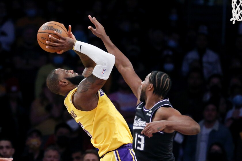 Lakers forward LeBron James attempts a shot over Kings forward Tristan Thompson.