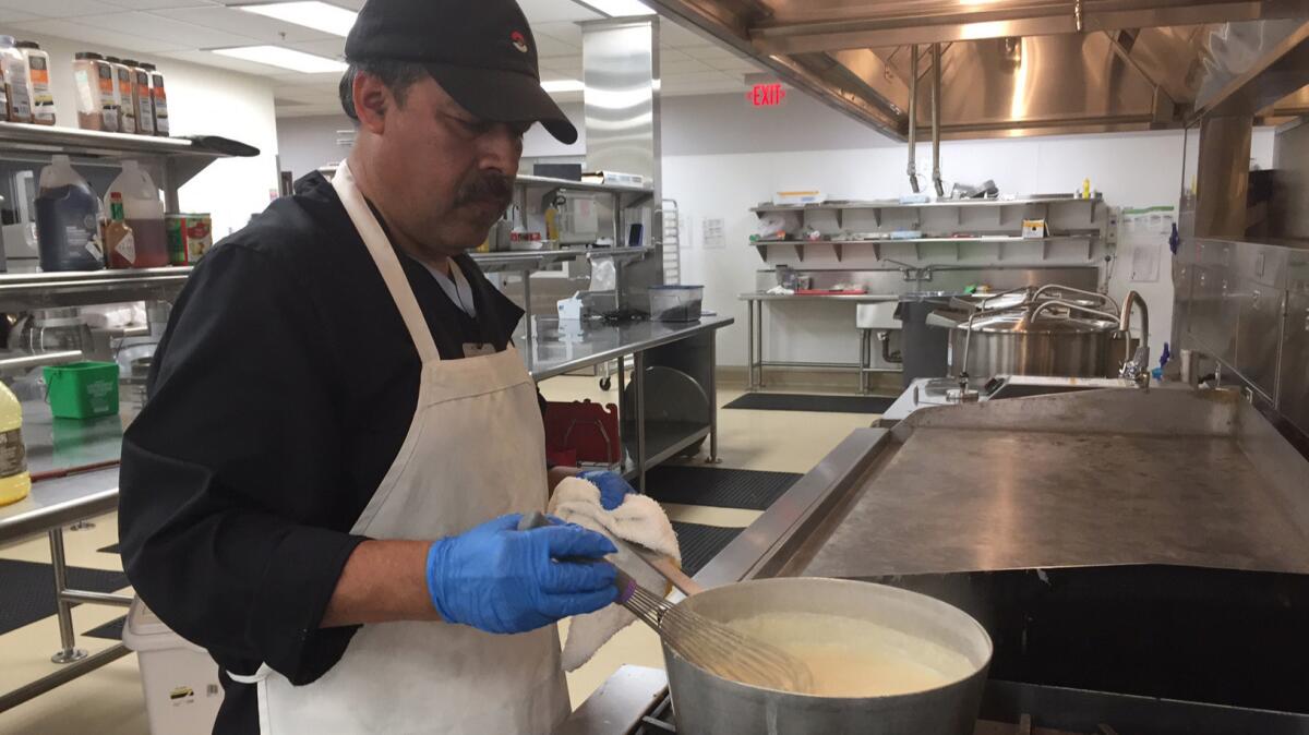 Miguel Veliz stirs the gravy in a new CalVet kitchen in West Los Angeles.