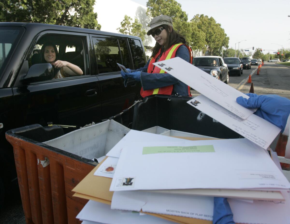 People line up to drop off their tax returns to Julie Luu at the deadline at the Santa Ana post office in 2008.