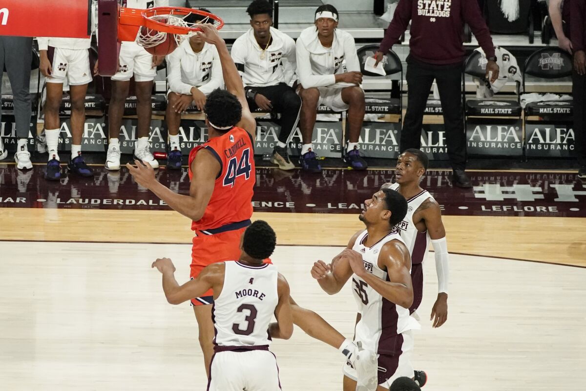 Auburn center Dylan Cardwell (44) dunks in front of Mississippi State players during the first half of an NCAA college basketball game in Starkville, Miss., Wednesday, March. 2, 2022. (AP Photo/Rogelio V. Solis)