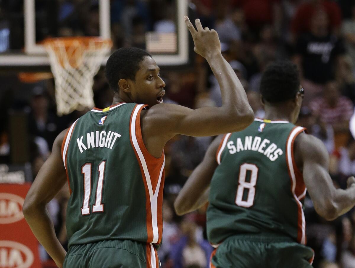 Milwaukee Bucks guard Brandon Knight celebrates after scoring as he and center Larry Sanders head down court against Miami on Sunday night.