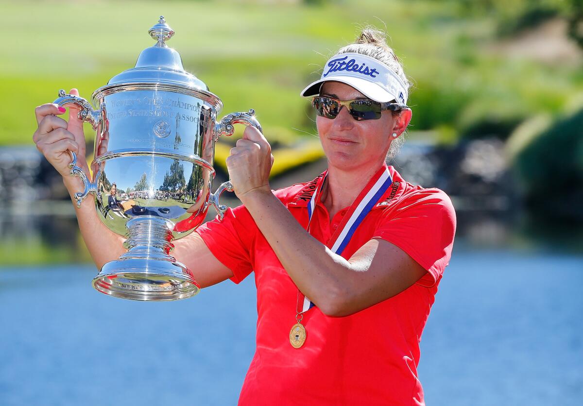 Brittany Lang poses with the trophy on the 18th green after defeating Anna Nordqvist in a three-hole playoff to win the U.S. Women's Open at CordeValle Golf Club.