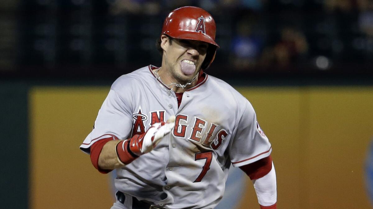 Angels baserunner Collin Cowgill sprints to third on his bases-clearing triple in the eighth inning of a 9-3 victory over the Texas Rangers on Tuesday.
