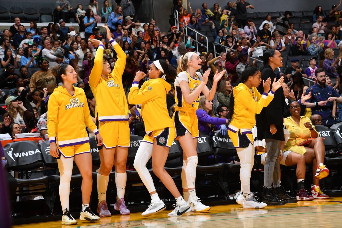Sparks players on the bench celebrate during the team's win over the Dallas Wings on Friday at Crypto.com Arena.