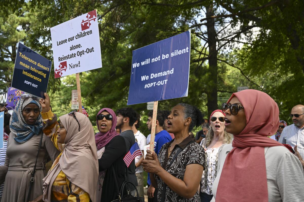 A group of parents gather to protest a policy that doesn't allow them to opt their children out of lessons.