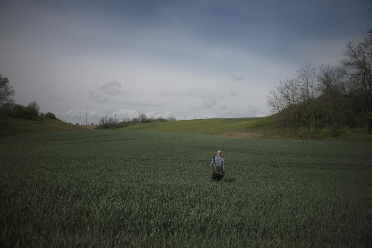 Thomas Siepert a volunteer from the Assn. for the Recovery of the Fallen in Eastern Europe walks  in a former battlefield near Klessin. 