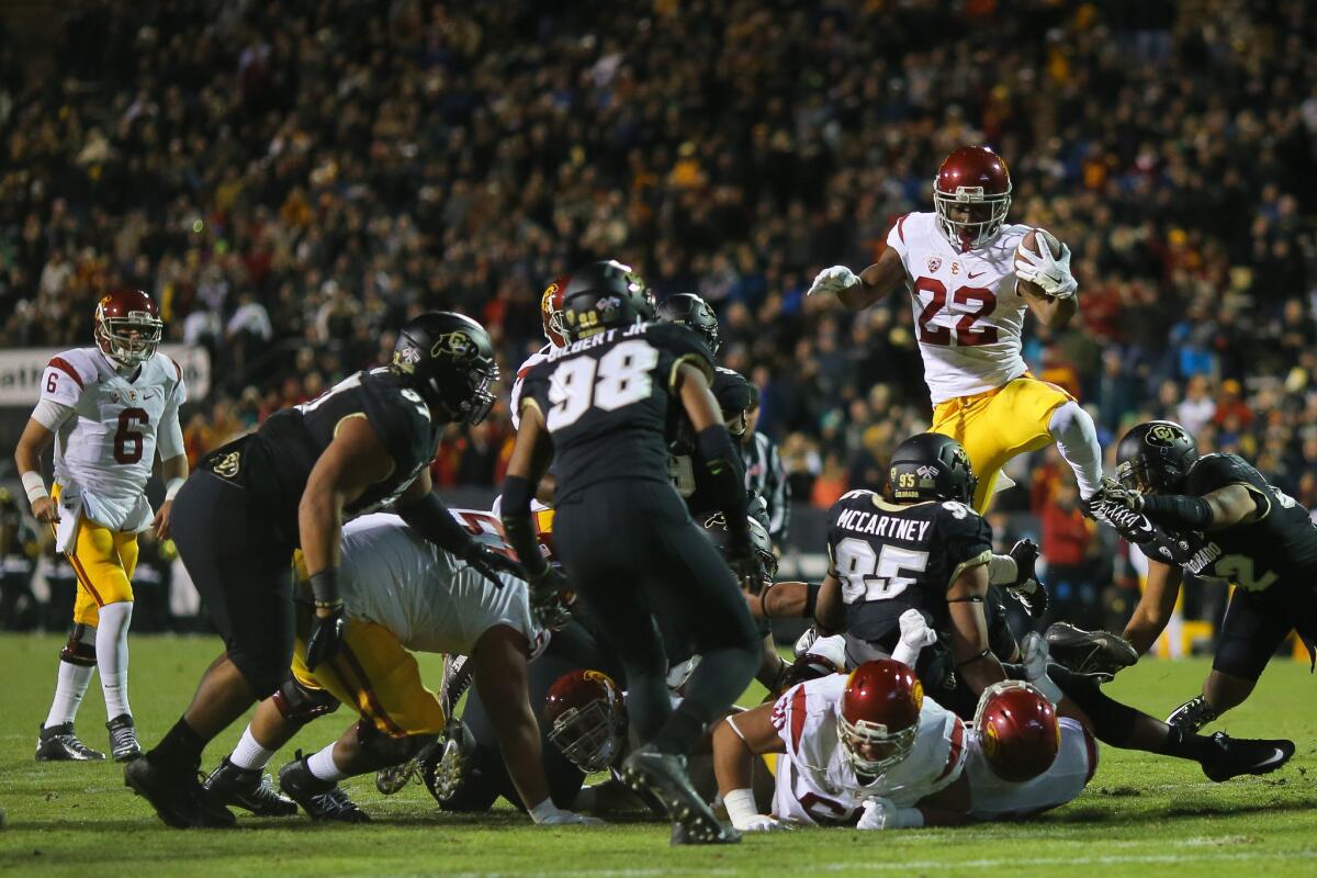USC running back Justin Davis leaps over the line for a three-yard gain in the first half.