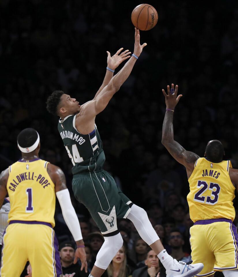Bucks forward Giannis Antetokounmpo puts up a shot over LeBron James during the second half of a game March 6 at Staples Center.
