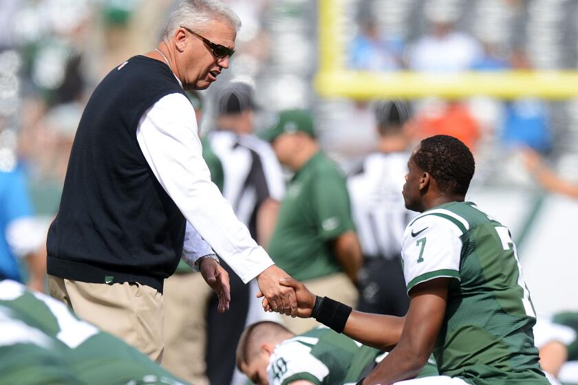 New York Jets Coach Rex Ryan shakes hands with quarterback Geno Smith before their game Sunday against the Detroit Lions at MetLife Stadium.