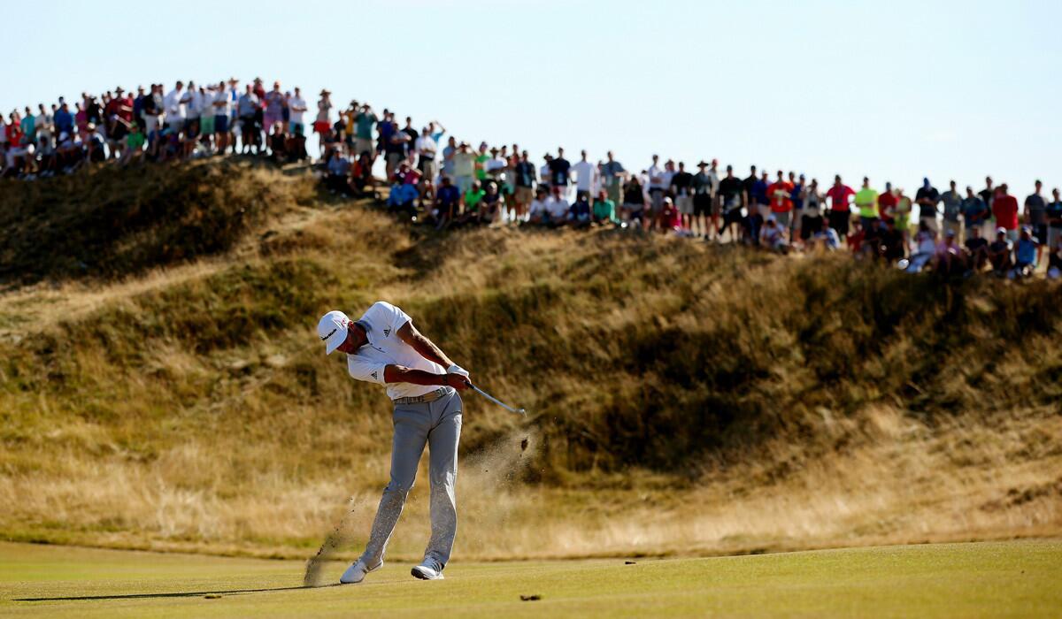 Dustin Johnson hits his second shot on the 11th hole during the final round of the 115th U.S. Open Championship on Sunday.