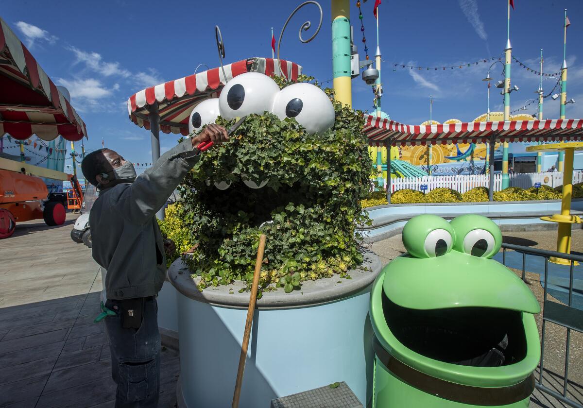 A horticulturist trims a topiary at Universal Studios Hollywood